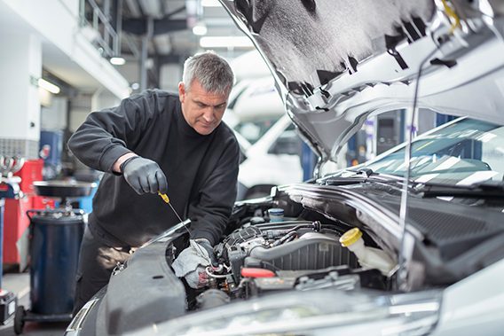 Tire Town Auto Care Center | mechanic working on engine of car in the shop